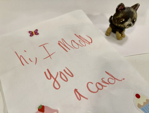A card that says "Hi, I made you a card" with a little painted toy dog beside it.